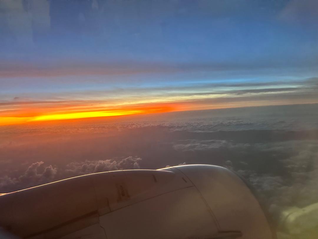 Sunset above the clouds seen from an aircraft window