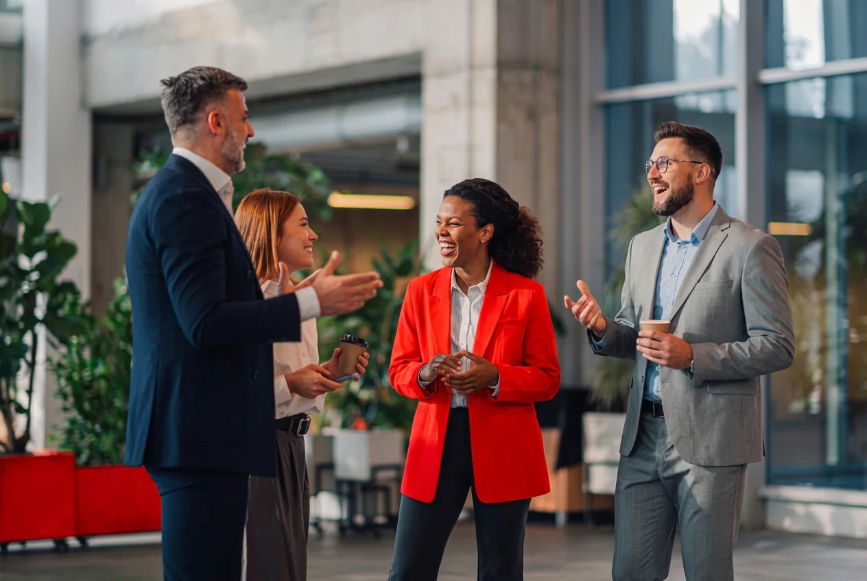 A diverse group of business professionals talking together in a modern office